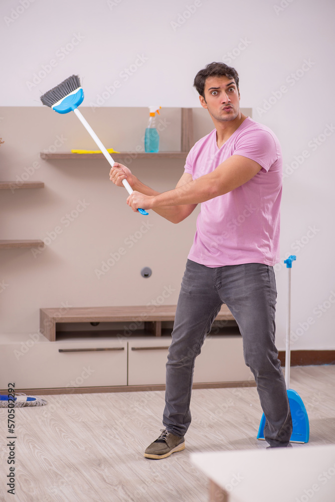 Young male contractor cleaning the house Young male contractor cleaning the house