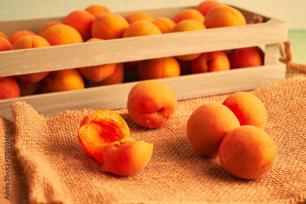 ripe juicy apricots in a wooden box and on burlap ripe juicy apricots in a wooden box and on burlap
