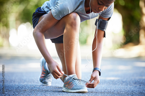 Shoes, running and athlete tie laces ready to exercise, workout or fitness outdoors in a park by female training. Active, fit and closeup of person or runner preparing to jog for health and wellness