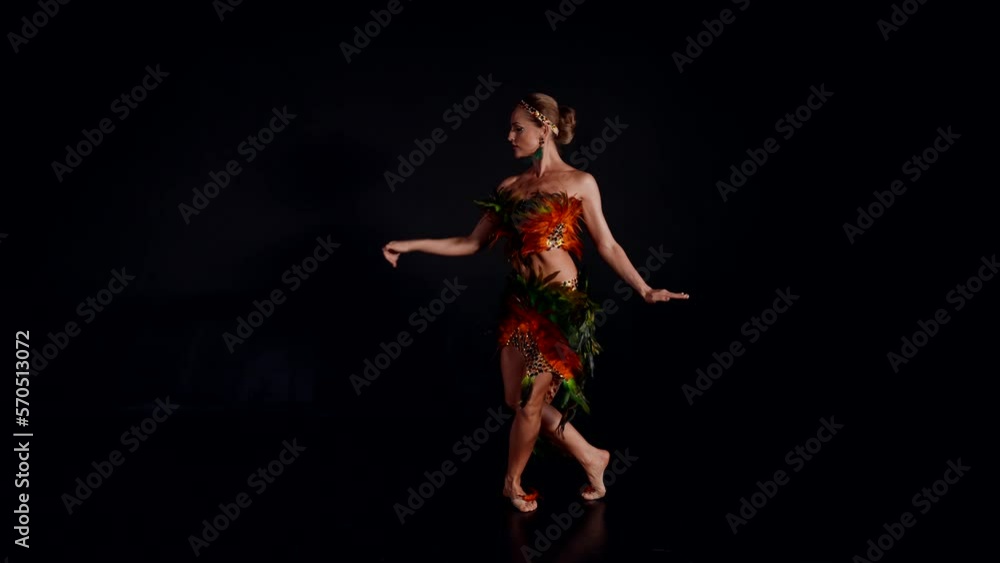 barefoot woman dancing wild passionate dance in black background, full-length portrait barefoot woman dancing wild passionate dance in black background, full-length portrait