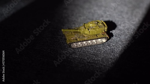 Close-up shot of an isolated radio-controlled toy tank that drives, rotates the turret and fires from the muzzle. Military children's toys. A game of war games with heavy weapons. RC toy tank.