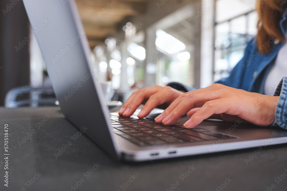 Closeup image of a woman working and typing on laptop computer keyboard Closeup image of a woman working and typing on laptop computer keyboard