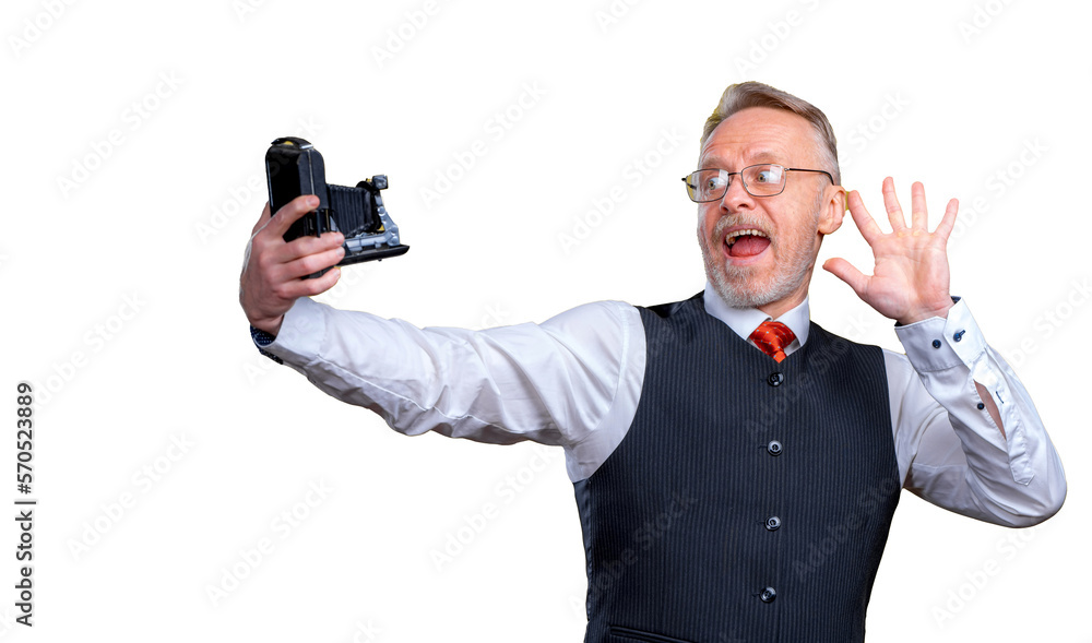 Senior man looking at camera while taking silly face selfie. Waving to the camera Senior man looking at camera while taking silly face selfie. Waving to the camera