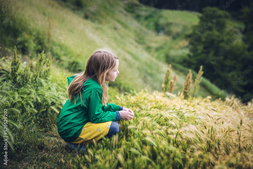 Child Looking Off Grassy Hillside in Belgrade, Serbia Child Looking Off Grassy Hillside in Belgrade, Serbia