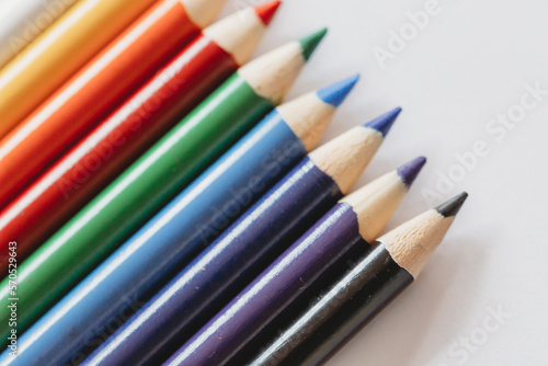 Multi-colored coloring pencils on white background photo