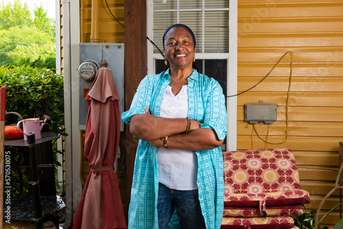 Portrait of a smiling African-American woman standing arms crossed