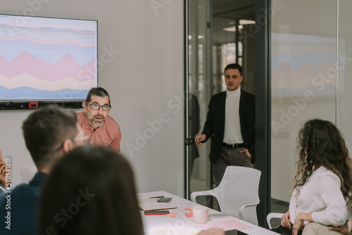 Junior male person is late at the meeting. He has just arrived