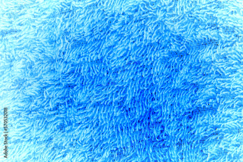 Macrophotography of blue fabric with fibers.
