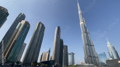 Shot from the ground with a Burj Khalifa skyscraper tower wide angle lens. The tallest building in the world. Filmed during the day with fountain in front. UAE