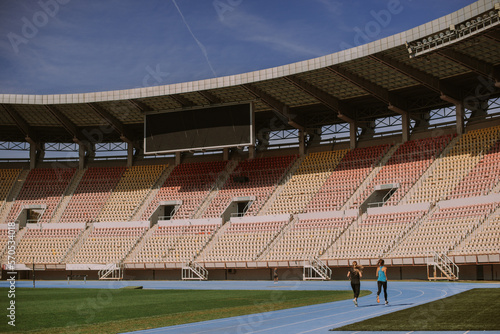 Girls running on a blue sports track