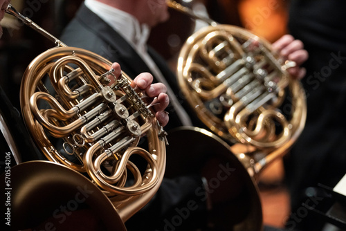 French horn players playing during a classical symphony orchestra concert