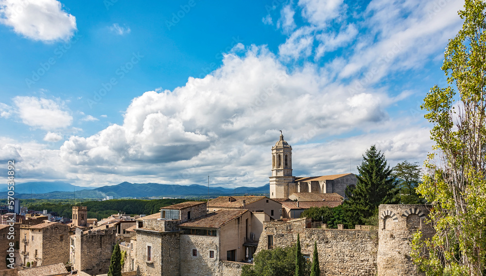 The architecture of the historic part of the city with a view of the Church of St. Philip (Girona, Spain)