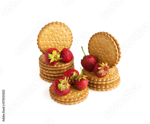 On a white background is a two-layer cookies and red strawberries © Pavel