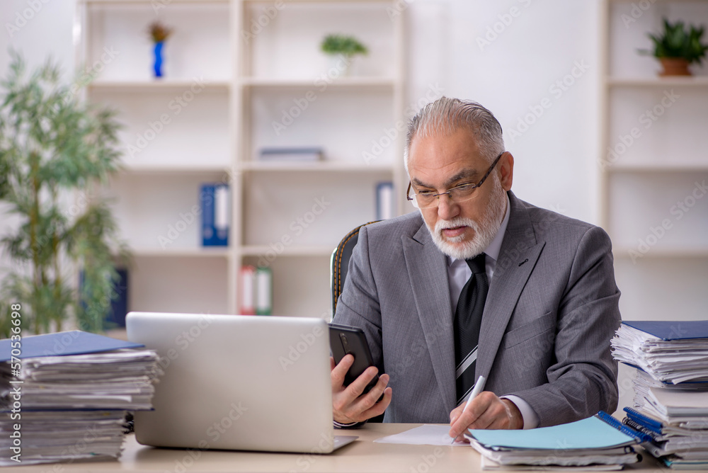 Old male employee and too much work in the office Old male employee and too much work in the office