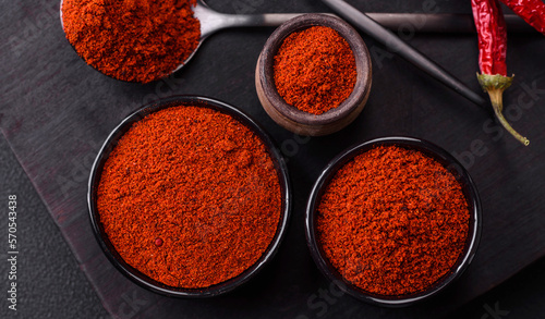 Spice smoked paprika in the form of powder in bowls and spoons