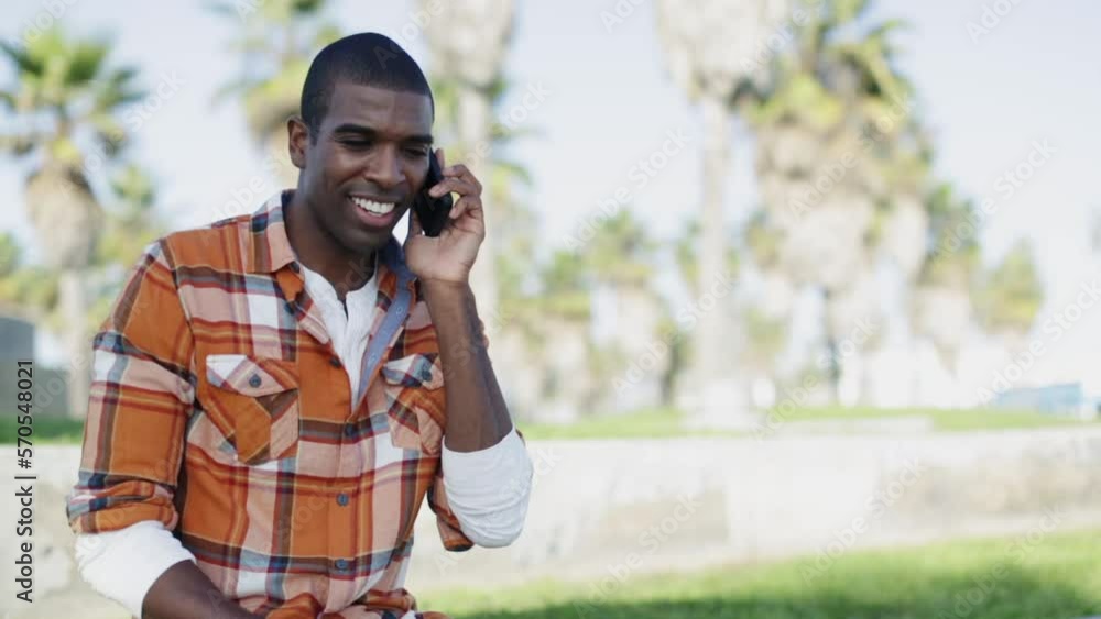 Man answering cell phone by the beach Man answering cell phone by the beach
