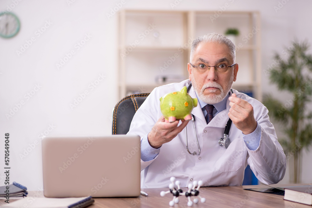 Old male doctor in planning retirement concept Old male doctor in planning retirement concept