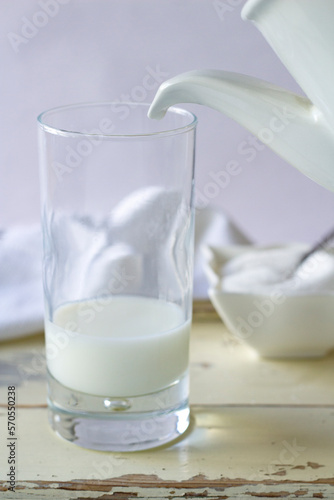 Milk jug and glass in white tone.