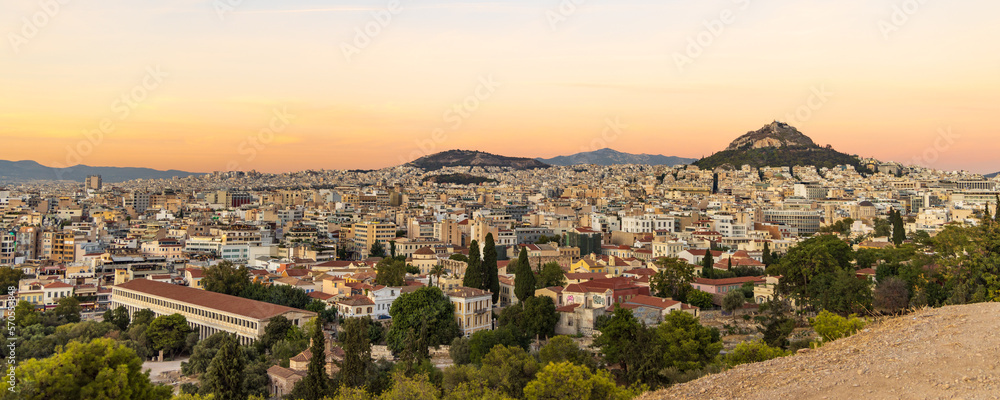 View from the hill of the Acropolis site on a sunny evening during sunset in Athens Greece
