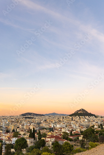 View from the hill of the Acropolis site on a sunny evening during sunset in Athens Greece © HildaWeges
