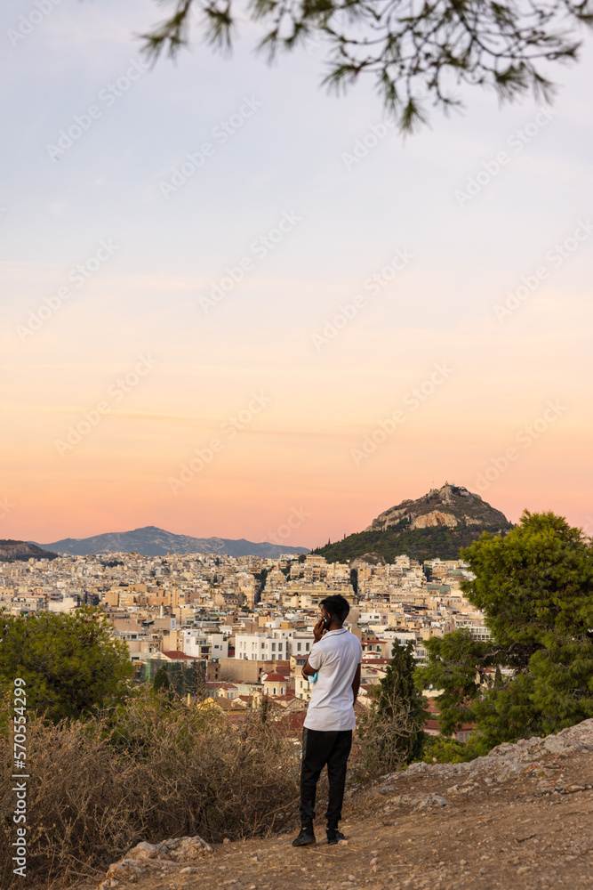 View from the hill of the Acropolis site on a sunny evening during sunset in Athens Greece