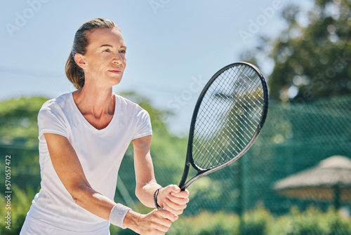 Senior woman, tennis player and ready in sports game for ball, match or hobby on the court. Happy elderly female in sport fitness holding racket smiling in stance for training or practice outdoors © Delcio/peopleimages.com