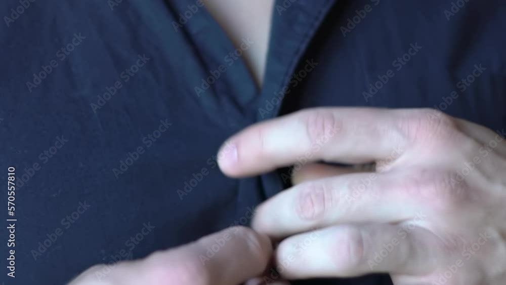 Young Man Unbuttoning A Blue Shirt Close-Up Young Man Unbuttoning A Blue Shirt Close-Up