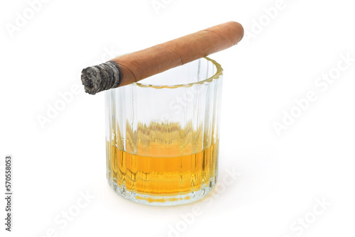 Whisky glass and tobacco cigar burned with ash isolated on white
