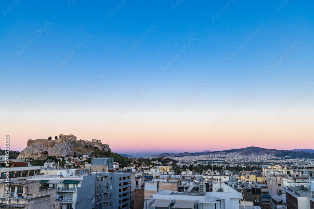 Cityscape of Athens during sunset with view of the acropolis and Parthenon temple in Greece
