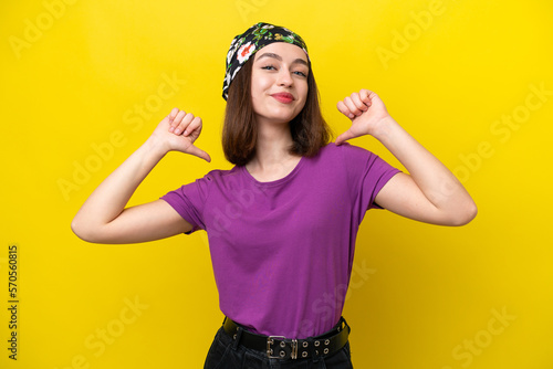 Young Ukrainian woman isolated on yellow background proud and self-satisfied