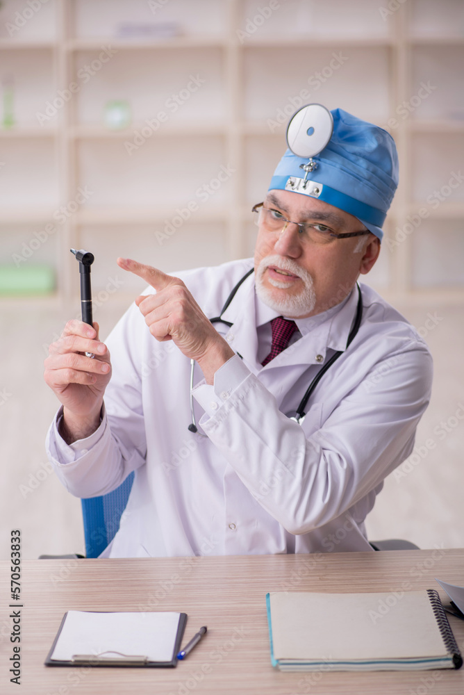 Old male doctor otorhinolaryngologist working in the clinic Old male doctor otorhinolaryngologist working in the clinic