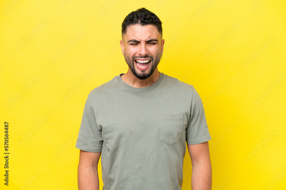 Young Arab handsome man isolated on yellow background shouting to the front with mouth wide open Young Arab handsome man isolated on yellow background shouting to the front with mouth wide open