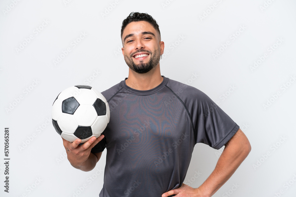 Arab young football player man isolated on white background posing with arms at hip and smiling