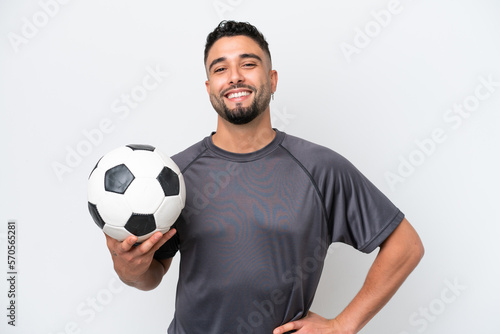 Arab young football player man isolated on white background posing with arms at hip and smiling