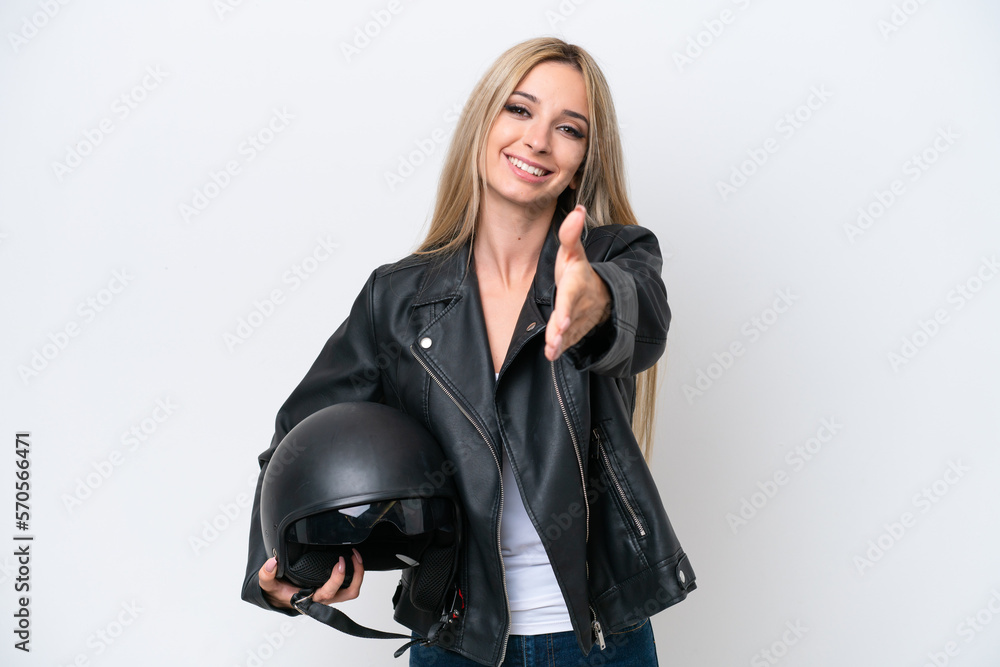 Pretty blonde woman with a motorcycle helmet isolated on white background shaking hands for closing a good deal Pretty blonde woman with a motorcycle helmet isolated on white background shaking hands for closing a good deal