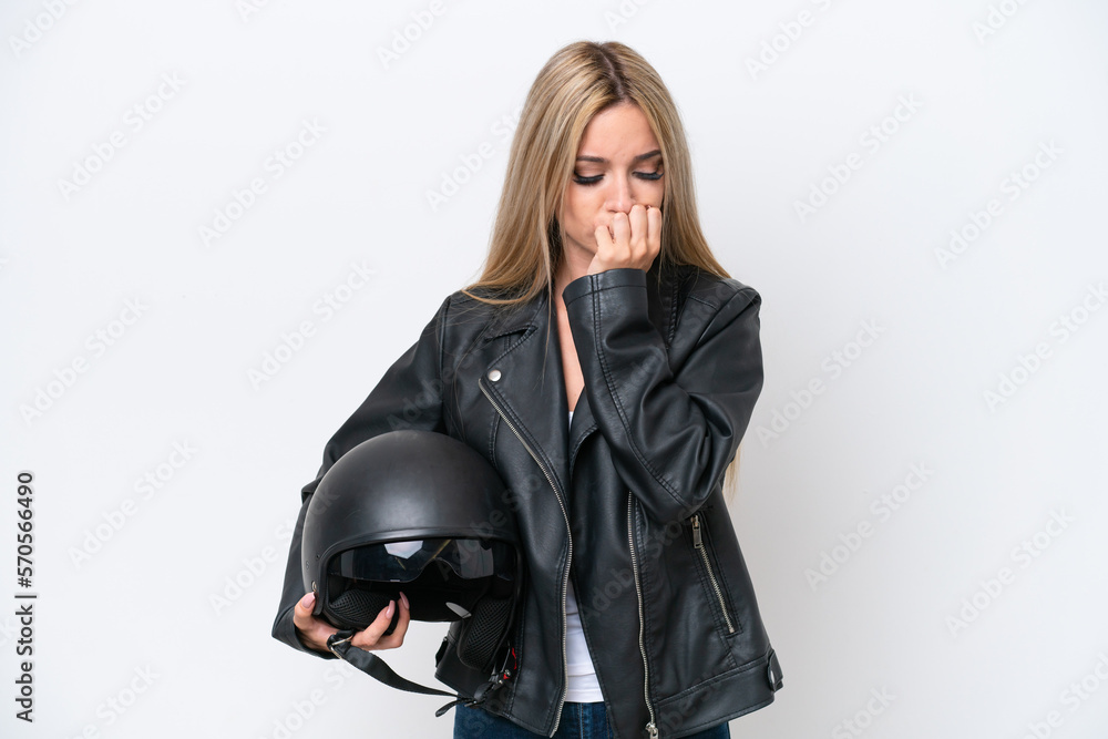 Pretty blonde woman with a motorcycle helmet isolated on white background having doubts Pretty blonde woman with a motorcycle helmet isolated on white background having doubts