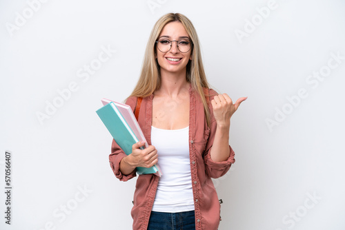 Pretty student blonde woman isolated on white background pointing to the side to present a product