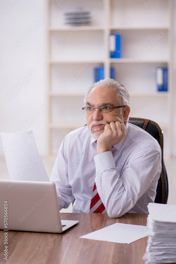 Old male employee and too much work in the office Old male employee and too much work in the office
