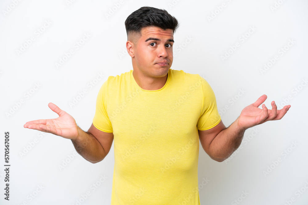 Young caucasian handsome man isolated on white background having doubts while raising hands Young caucasian handsome man isolated on white background having doubts while raising hands