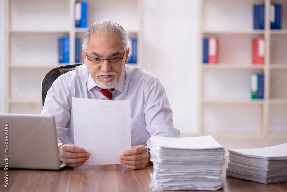 Old male employee and too much work in the office Old male employee and too much work in the office