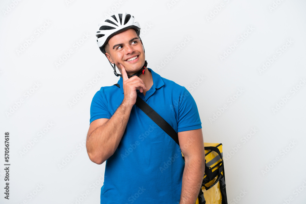 Young caucasian man with thermal backpack isolated on white background thinking an idea while looking up Young caucasian man with thermal backpack isolated on white background thinking an idea while looking up