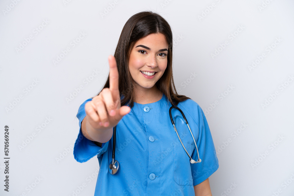 Young Brazilian nurse woman isolated on white background showing and lifting a finger Young Brazilian nurse woman isolated on white background showing and lifting a finger