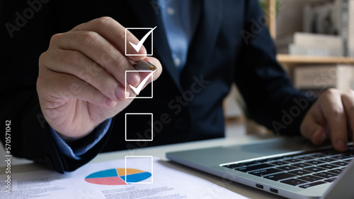 Businessman tick correct sign mark for document approve in checkbox, project acceptance and quality assurance concept, Take an assessment, questionnaire, evaluation, vote yes result. photo