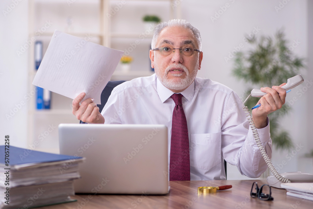 Old male employee and too much work in the office Old male employee and too much work in the office