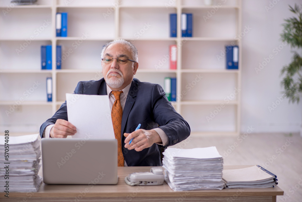 Old male employee and too much work in the office Old male employee and too much work in the office