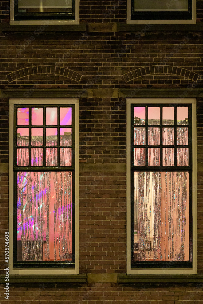 The Hague, Netherlands Residential windows on a brick building with party curtains. The Hague, Netherlands Residential windows on a brick building with party curtains.