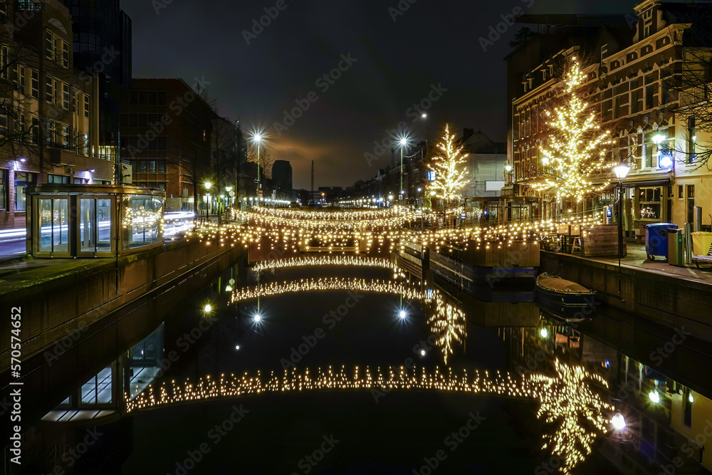 The Hague, Netherlands Christmas lights over a canal at night.