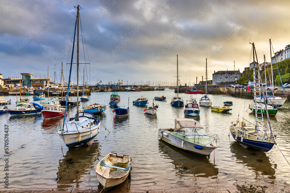 A summer sunrise at the picturesque Brixham harbour on the south coast of Devon.