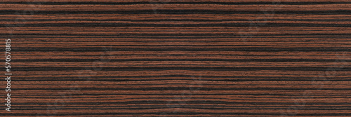 Macassar wood texture. High quality red and brown macassar wood plank surface texture. The texture of hard and heavy wood, with a beautiful surface for the production of furniture or flooring photo