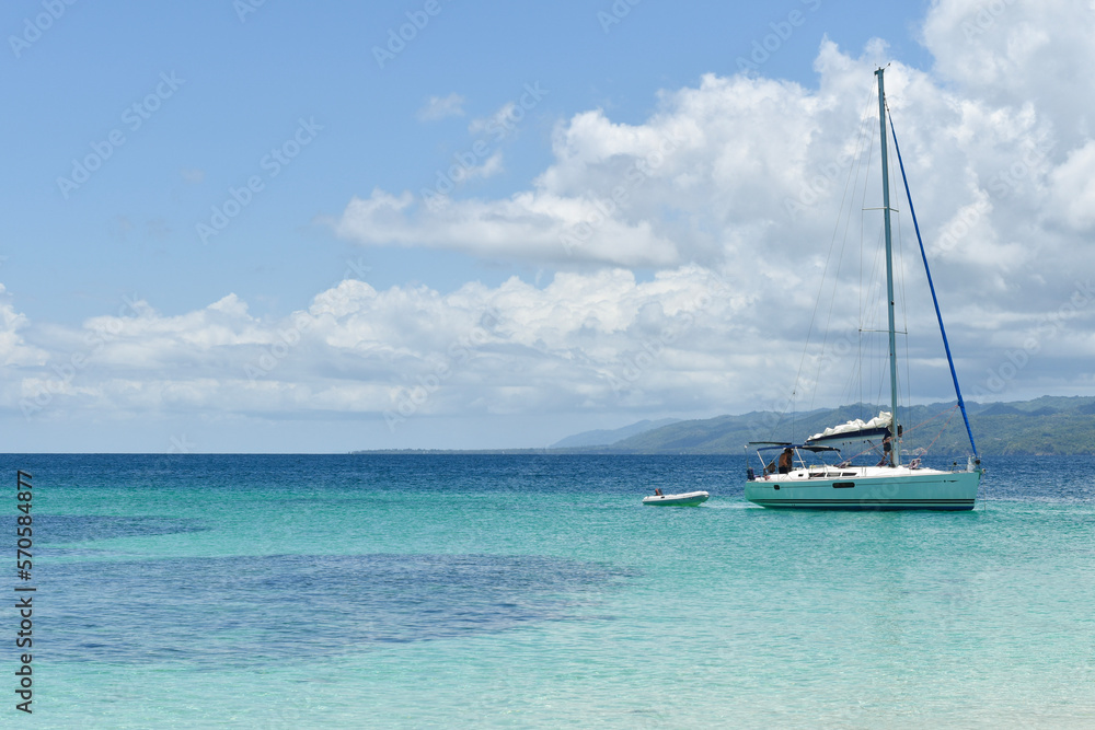 Beautiful bay with a sailing boat on the Caribbean beach. Cayo Levantado Island, Samana Bay, Dominican Republic.